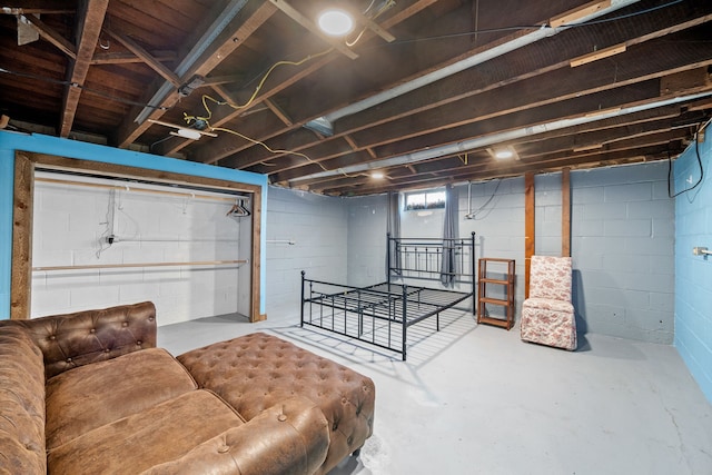 bedroom featuring concrete flooring