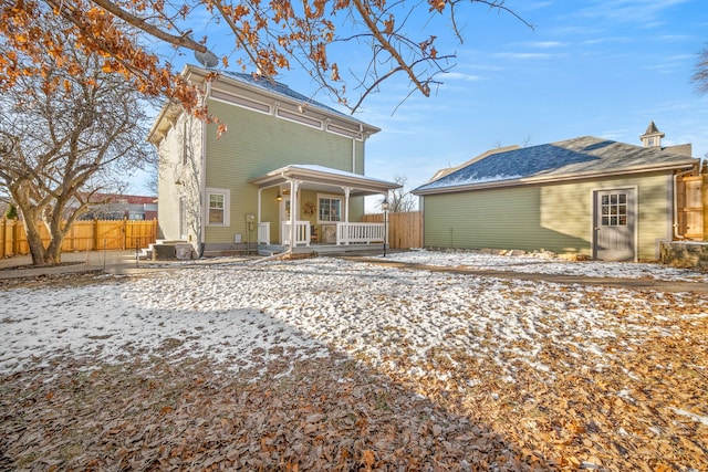 snow covered property featuring an outbuilding