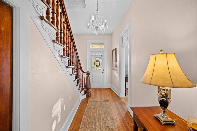 foyer featuring light hardwood / wood-style floors and a notable chandelier