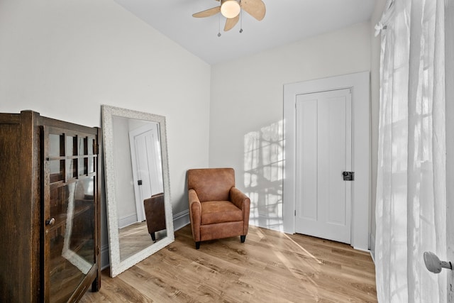 living area with ceiling fan and light wood-type flooring