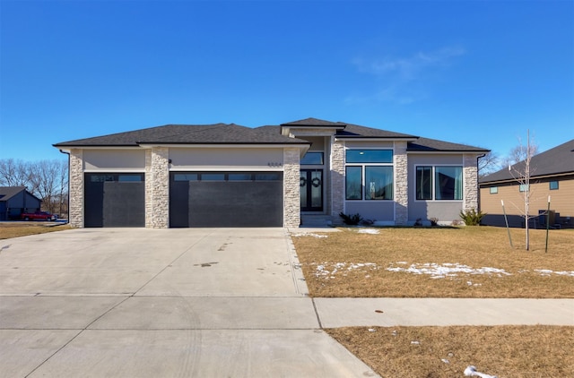 prairie-style house with a front yard and a garage