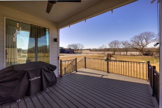 deck with ceiling fan, a rural view, and area for grilling