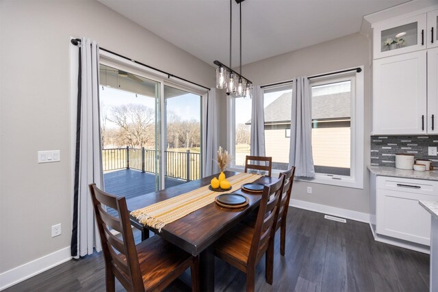 dining space with dark hardwood / wood-style floors