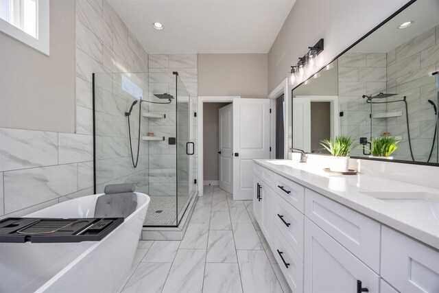 bathroom featuring tile walls, vanity, and plus walk in shower