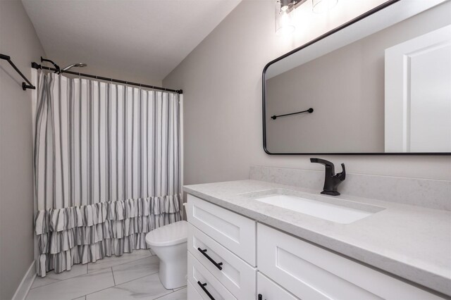 bathroom with toilet, vanity, and walk in shower