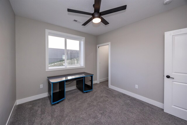 home office with ceiling fan and dark carpet