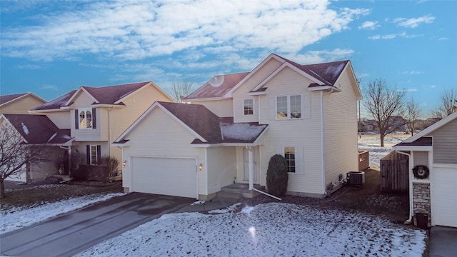 front facade featuring a garage and central air condition unit