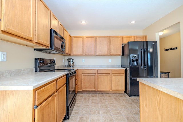 kitchen with light brown cabinets and black appliances