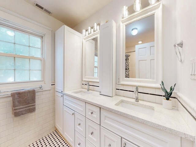 bathroom featuring walk in shower and vanity