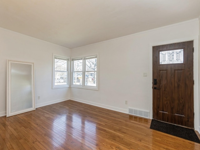 entrance foyer featuring ornamental molding and hardwood / wood-style flooring