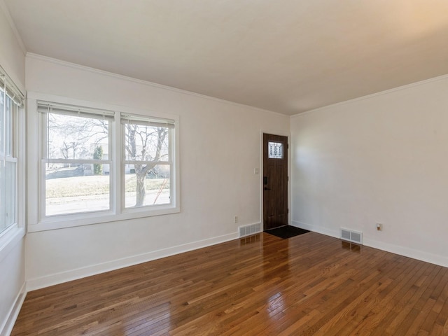 spare room featuring dark hardwood / wood-style flooring and ornamental molding