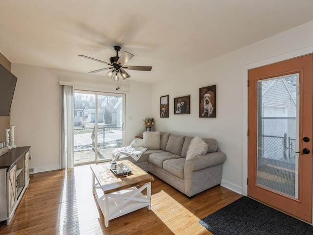 living room featuring ceiling fan and hardwood / wood-style flooring