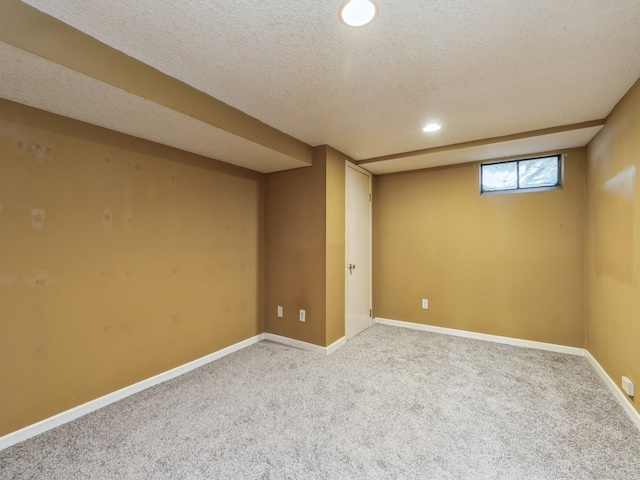 basement featuring carpet and a textured ceiling