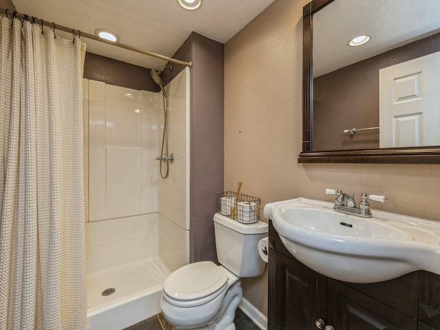 bathroom featuring toilet, vanity, and a shower with curtain