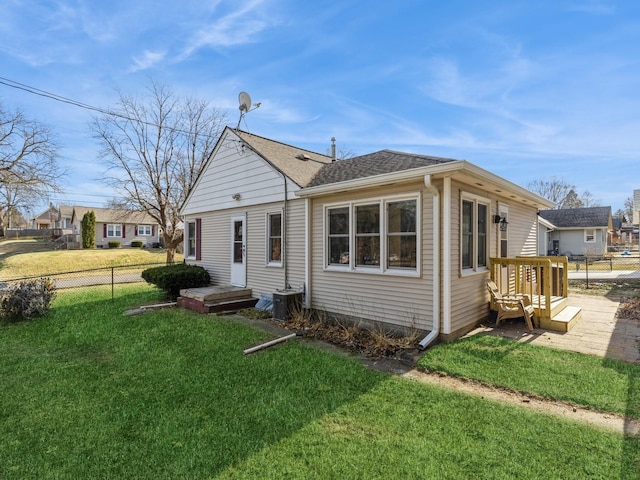 rear view of house featuring a lawn