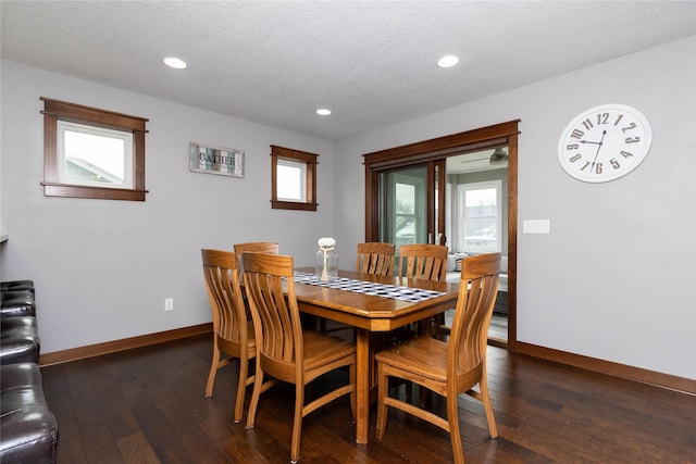 dining room featuring dark hardwood / wood-style floors and a textured ceiling