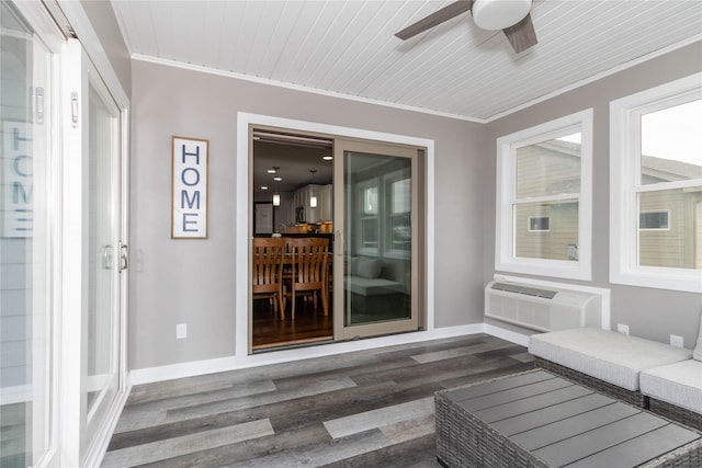 unfurnished sunroom with ceiling fan, a wall unit AC, and wood ceiling