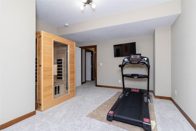 workout room with carpet and a textured ceiling