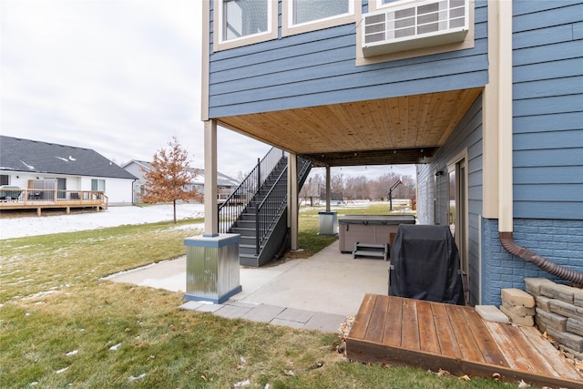 view of patio with a grill and a hot tub