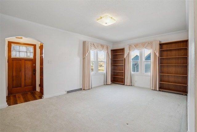 unfurnished room featuring carpet and ornamental molding