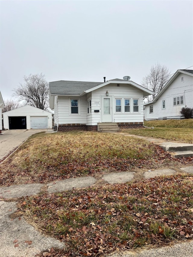 view of front of home with a garage and an outdoor structure