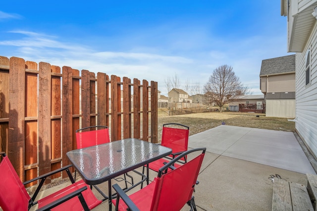 view of patio featuring fence and outdoor dining space