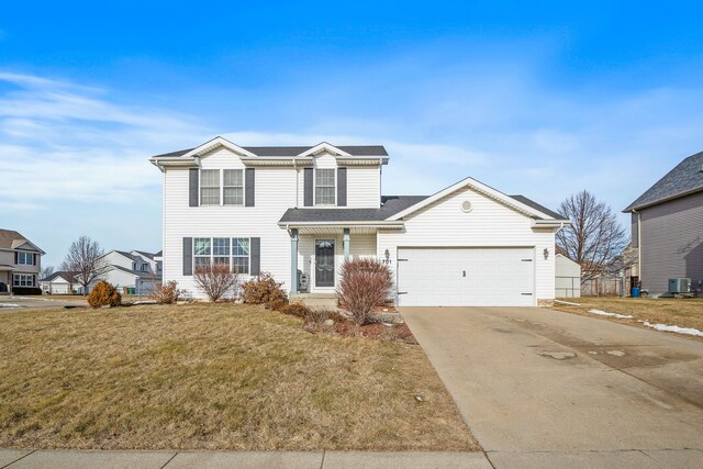 front of property with a front lawn, cooling unit, and a garage