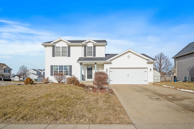 traditional-style home with a garage, concrete driveway, central AC, and a front yard