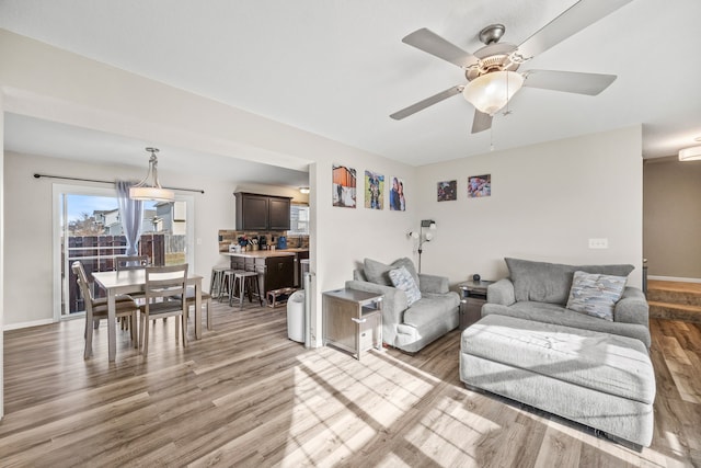 living room with hardwood / wood-style flooring and ceiling fan