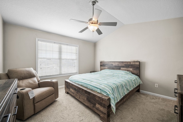 carpeted bedroom featuring ceiling fan, vaulted ceiling, and a textured ceiling