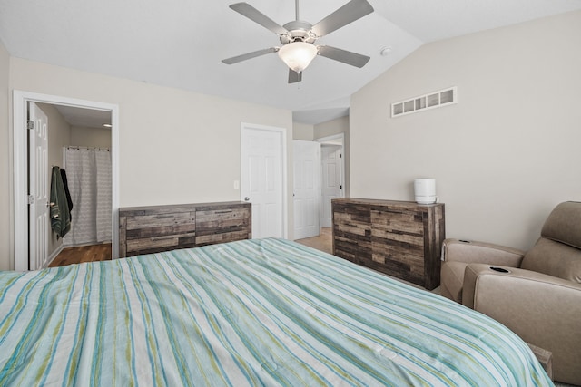 bedroom with vaulted ceiling, hardwood / wood-style floors, and ceiling fan