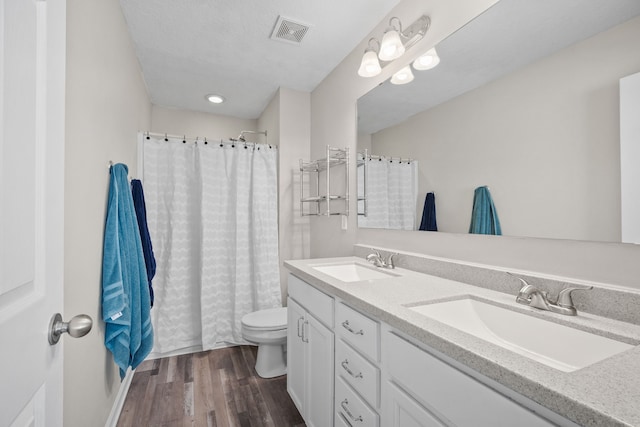 bathroom featuring vanity, toilet, and hardwood / wood-style floors