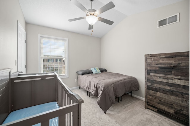 bedroom featuring ceiling fan, vaulted ceiling, and light carpet