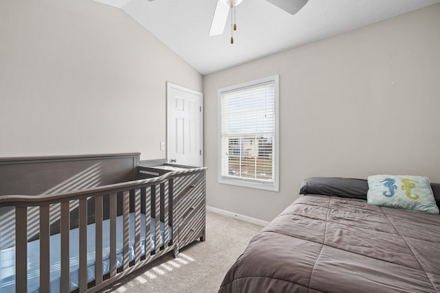 bedroom featuring baseboards, vaulted ceiling, a ceiling fan, and light colored carpet