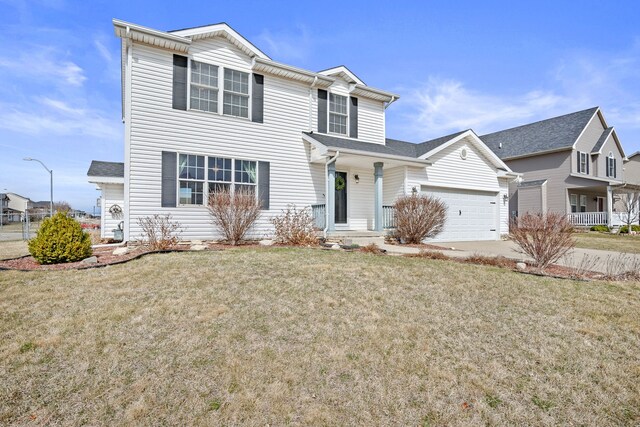 traditional-style house featuring concrete driveway, an attached garage, and a front lawn