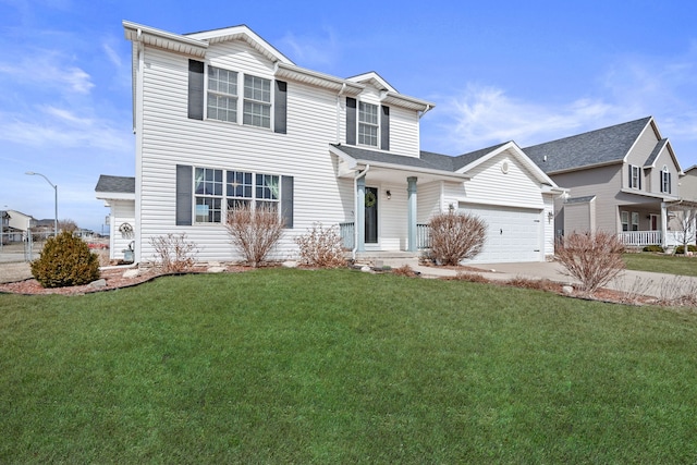 traditional-style home featuring a front lawn, a garage, and driveway