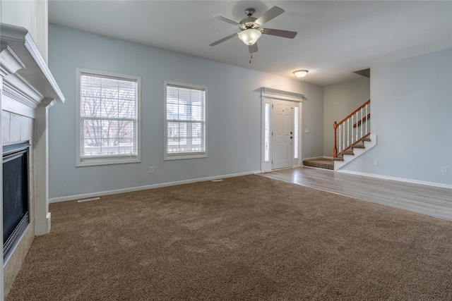 unfurnished living room with carpet floors and ceiling fan