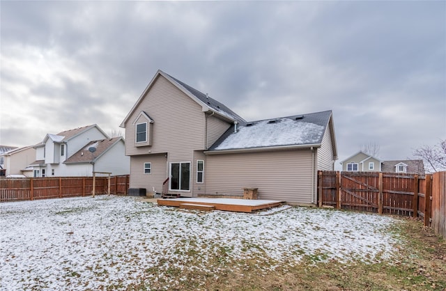 snow covered property with a deck