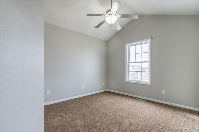 empty room with lofted ceiling, ceiling fan, and carpet floors