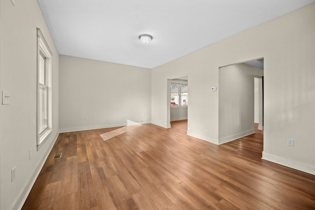 empty room with hardwood / wood-style flooring