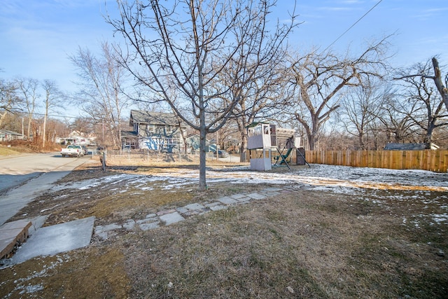 yard covered in snow with a playground