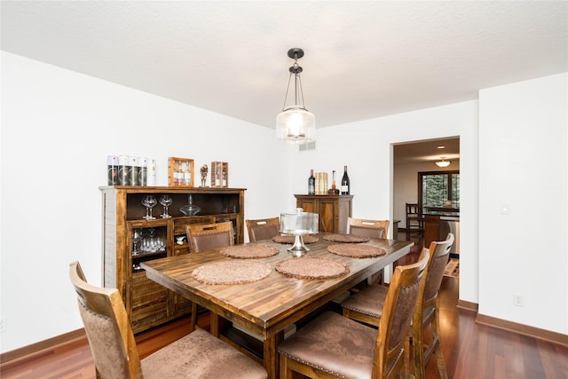 dining area with dark wood-type flooring