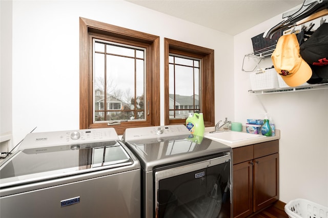 laundry room with cabinets, sink, dark hardwood / wood-style floors, and washing machine and dryer