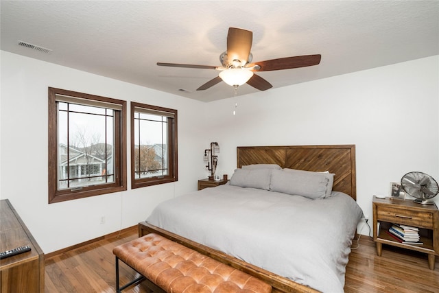 bedroom with ceiling fan and hardwood / wood-style floors