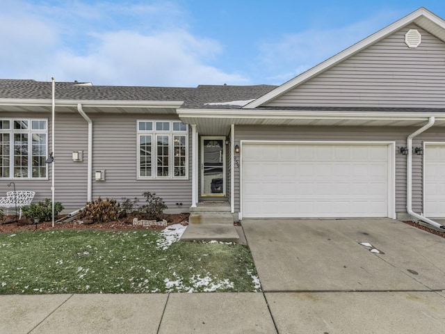 ranch-style house featuring a garage and a front yard