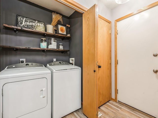 washroom featuring washer and dryer and light hardwood / wood-style flooring