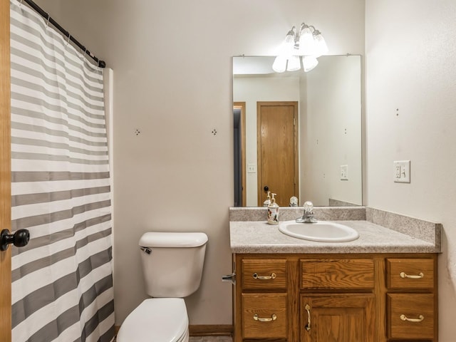 bathroom featuring vanity, a shower with shower curtain, and toilet