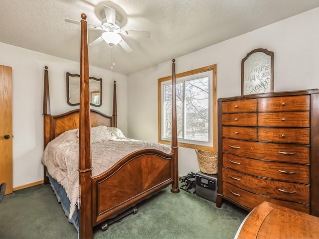 carpeted bedroom with ceiling fan and a textured ceiling