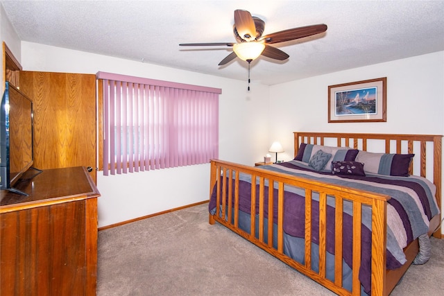 carpeted bedroom with a textured ceiling and ceiling fan