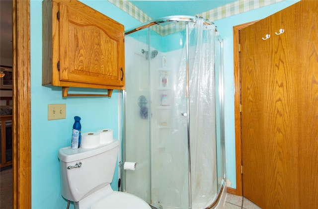 bathroom with walk in shower, tile patterned flooring, and toilet